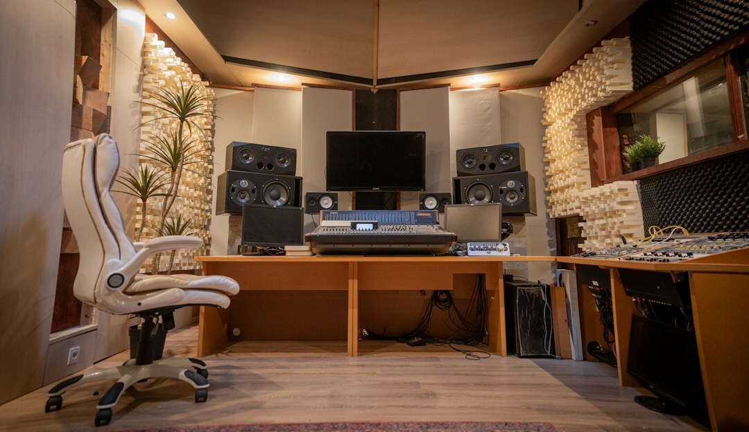 Wide view of a broadcast control room with editors and engineers working